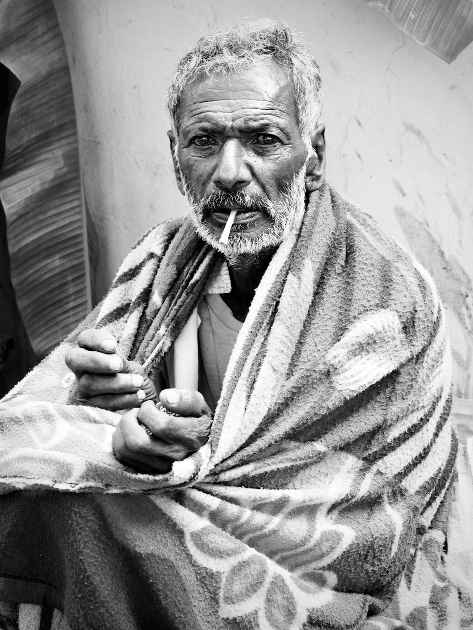 Man with glazed eyes and cigarette in his mouth.