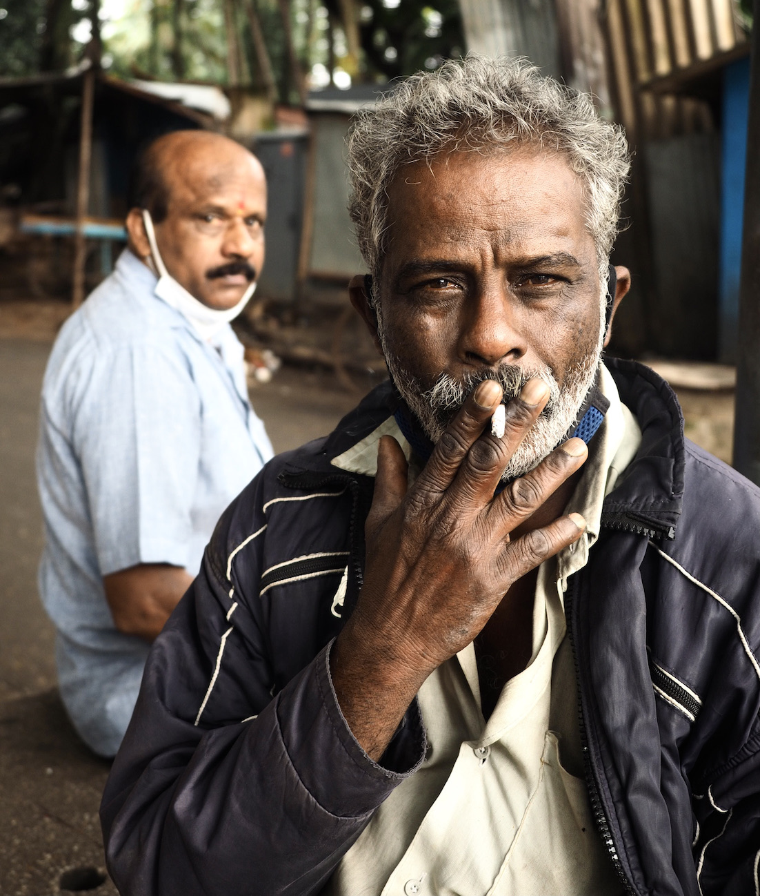Man with cigarette in his hand.